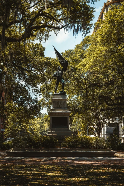 statue in park area in public place with trees