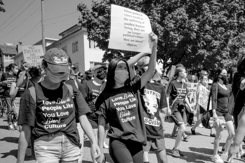 black and white pograph of group of people marching in protest