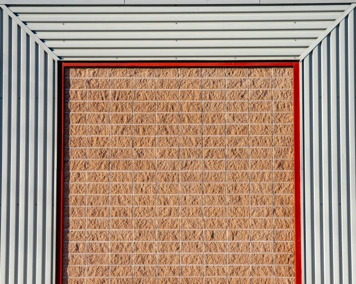 a red frame sitting next to a tan area rug