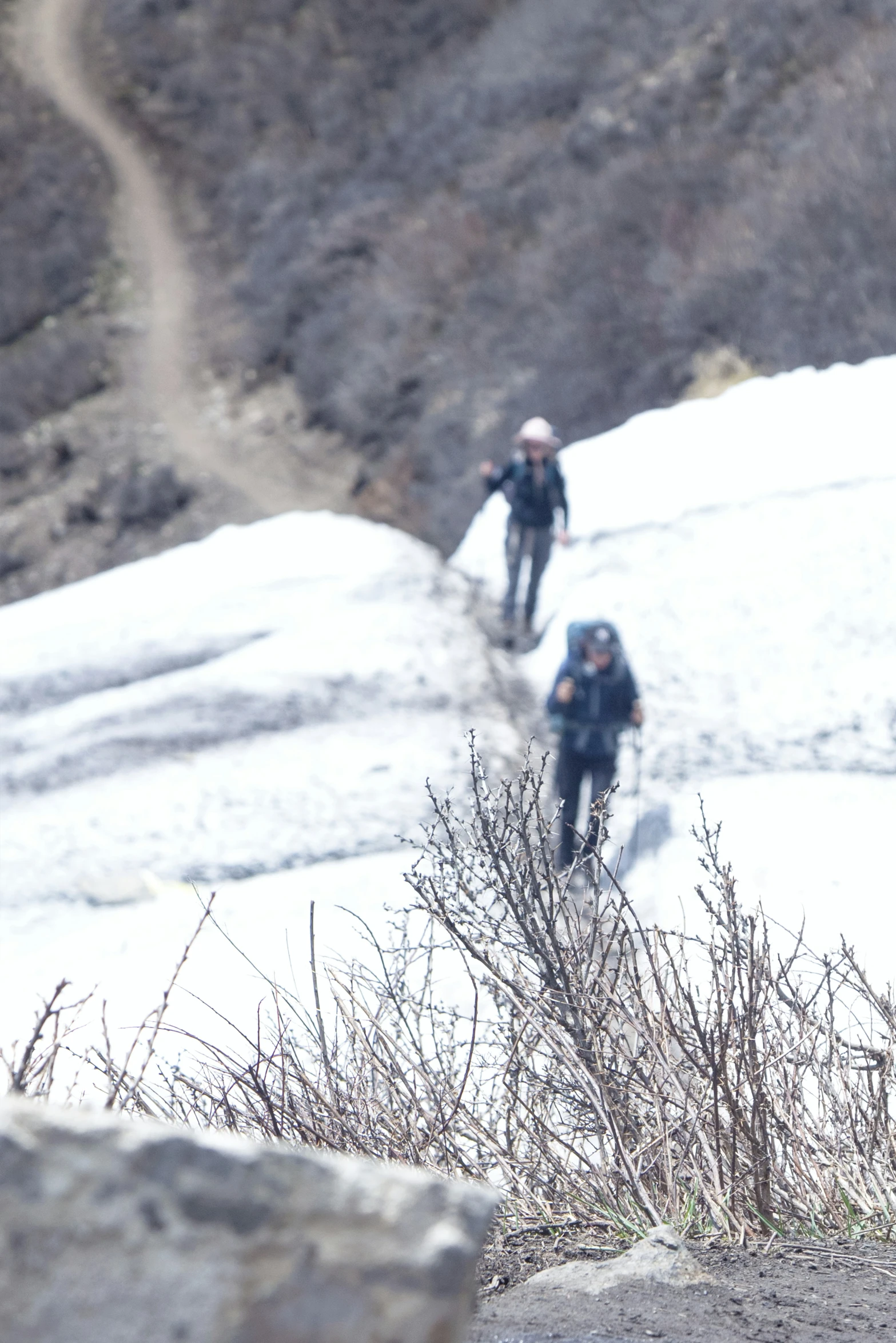 the snow boarders are headed down the snowy hill