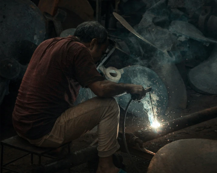 a man uses a grinder to cut through a rock