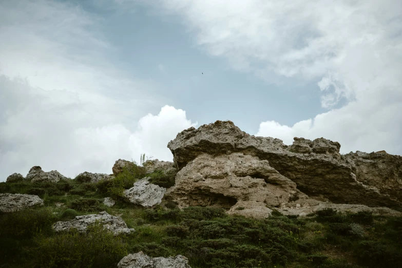 a mountain with some grass and rocks on it