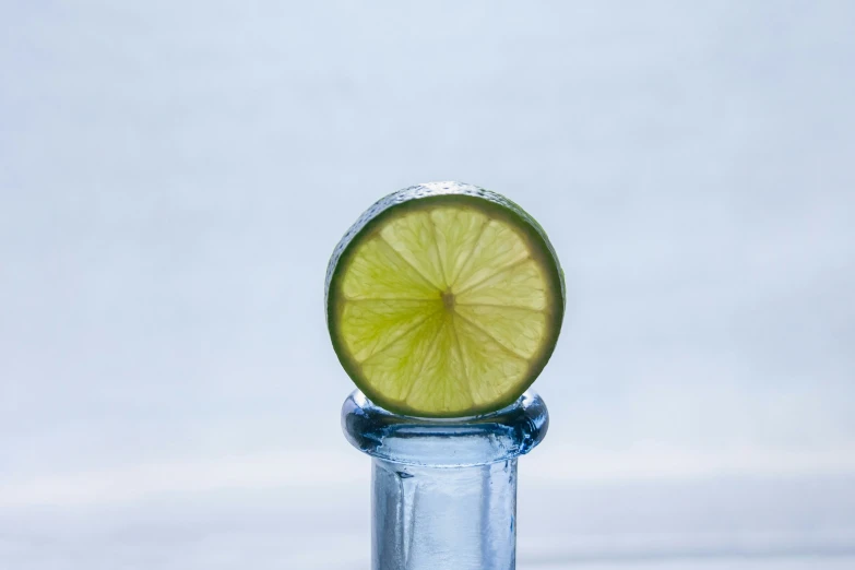 a water bottle covered with a piece of lime