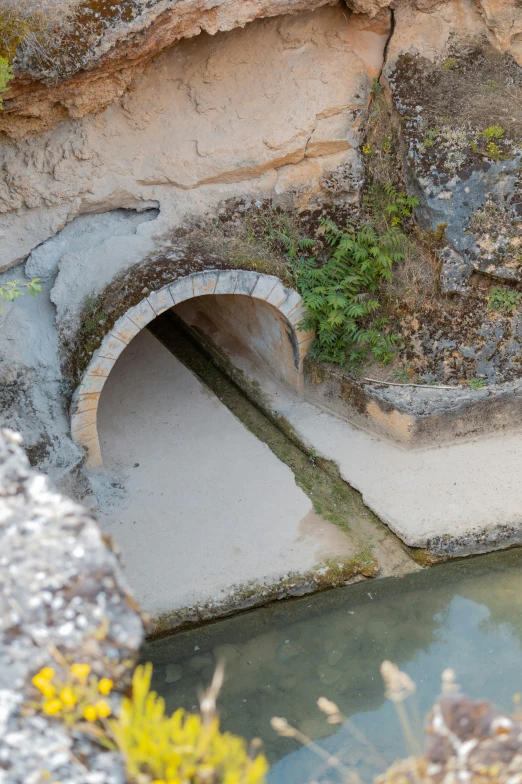 a water hole under the rocks that is made to look like a cave