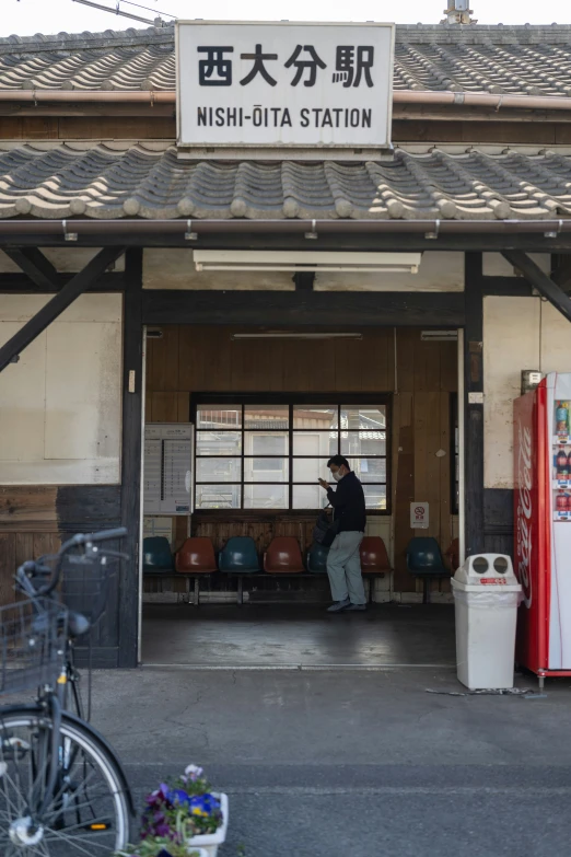 a person standing by some machines near some buildings