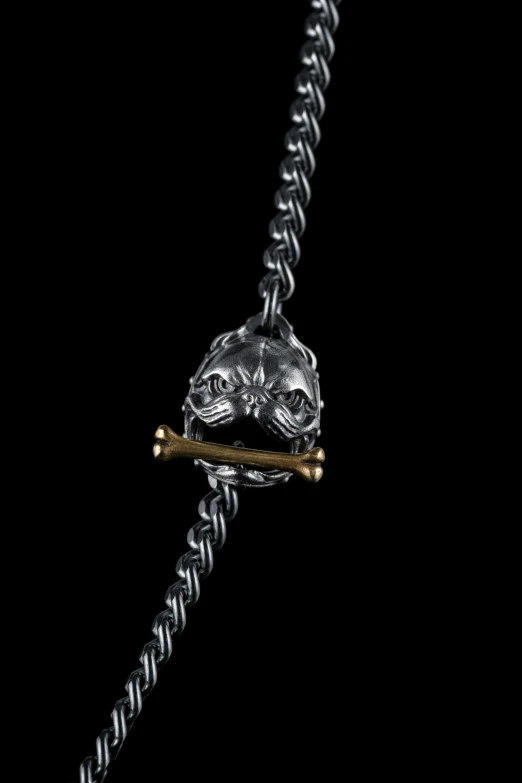 a watch with a stick in it and a chain on the watch