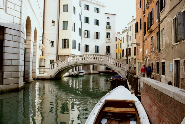 a boat in a body of water next to some buildings