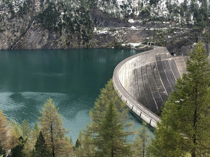 a water dam at the top of a large lake