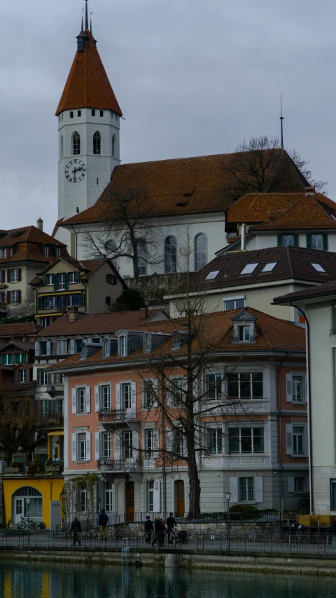 a clock tower towering over a city filled with tall buildings