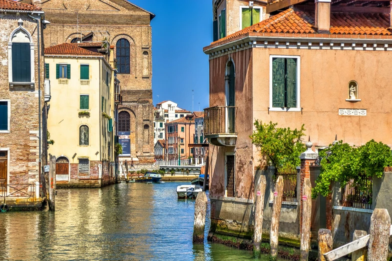 some buildings and boats in the water and a bridge