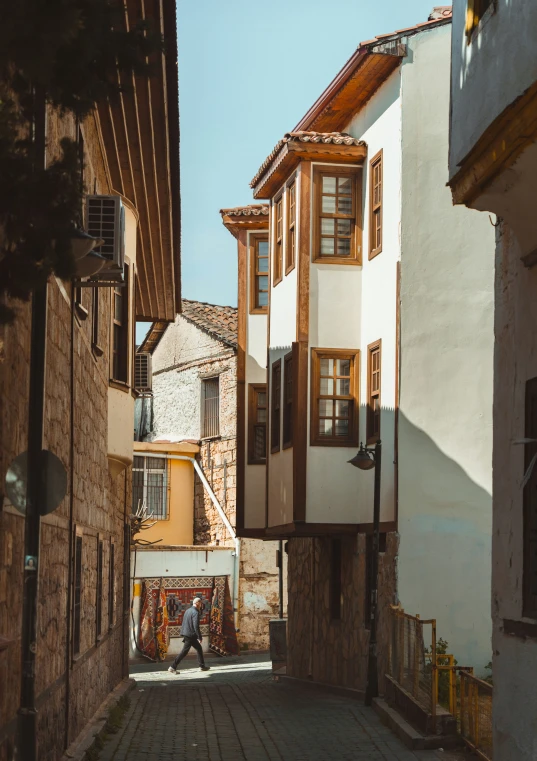 a man walks up the street while looking out over the side