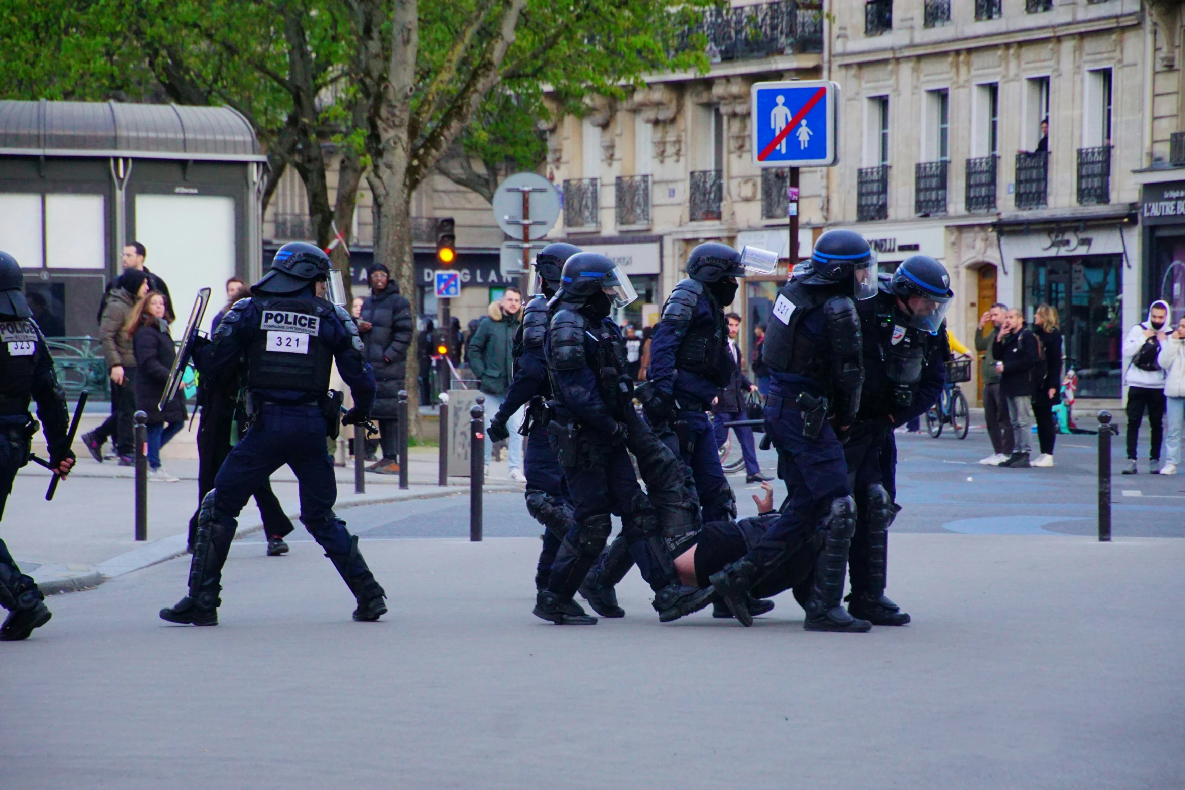 police officers are attempting to pull a person off the ground