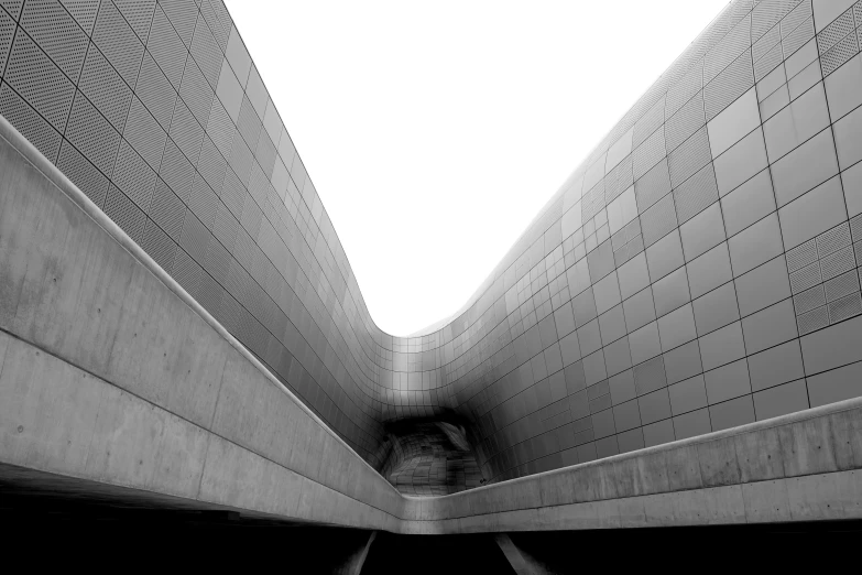 black and white image of a tunnel with sky above