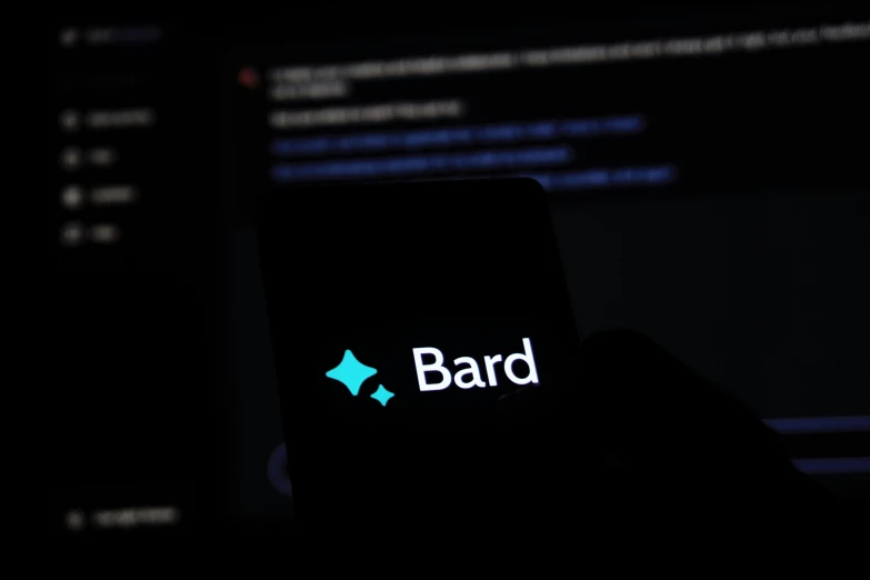 the dark background has an image of a mobile phone with bard on it