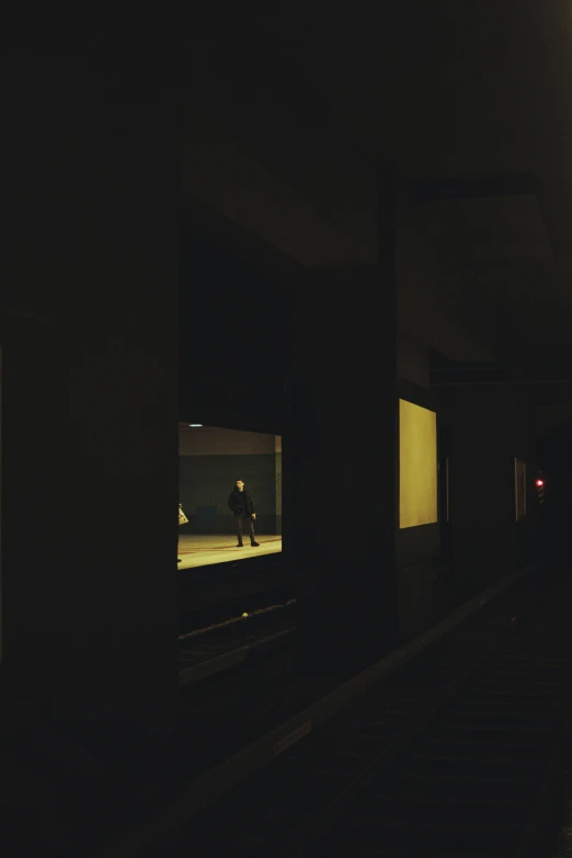 a dark po of some people on a train