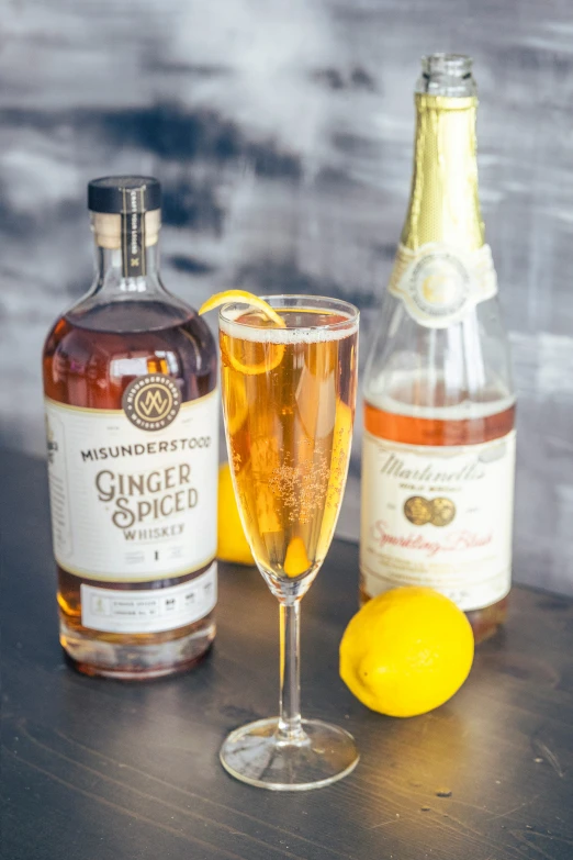 a glass of ginger spiced and an old fashioned bottle