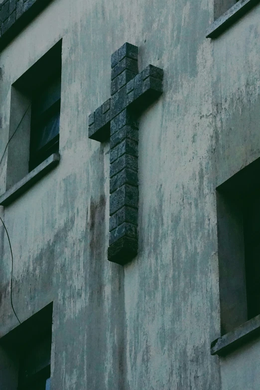 a cross that is on the side of a building