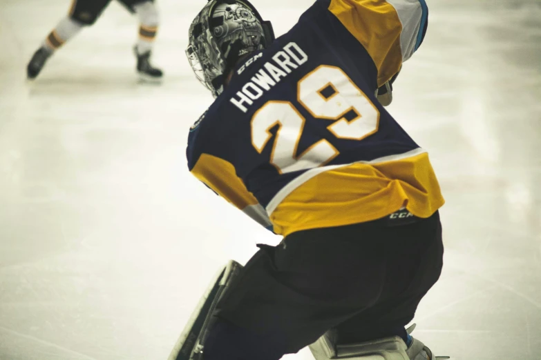 a man on a ice rink has his hands in the air