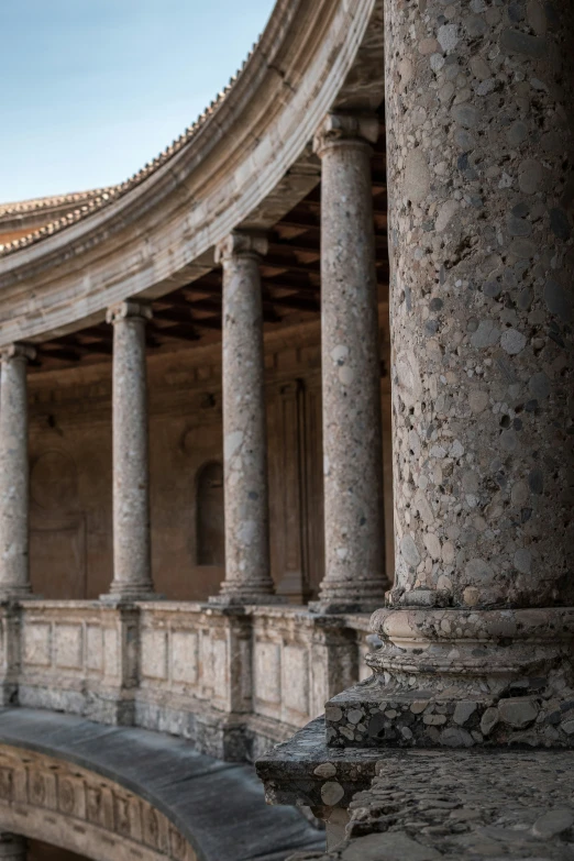 a woman looks up at the ceiling from the balcony of a building