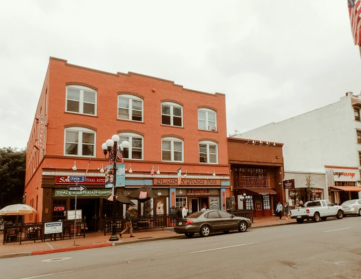 a two story red brick building on the corner