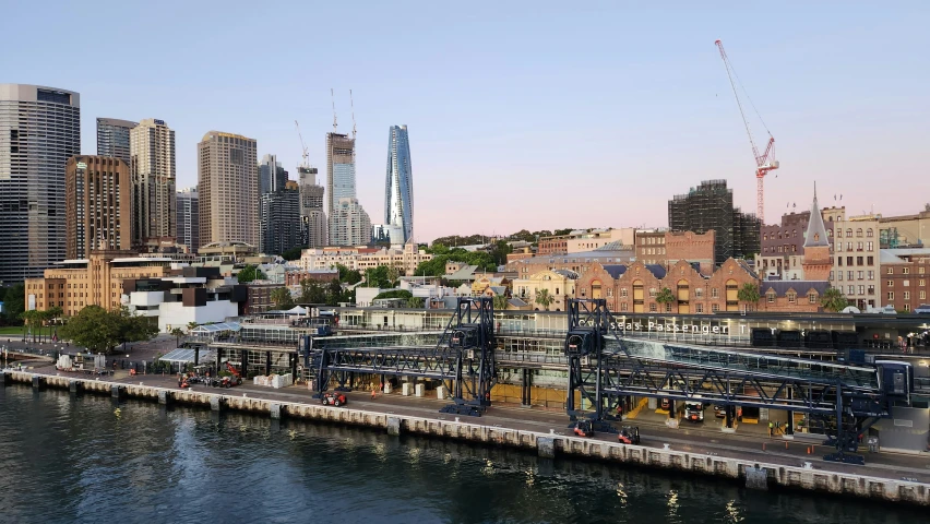 large, modern buildings and skyscrs line the water of a river