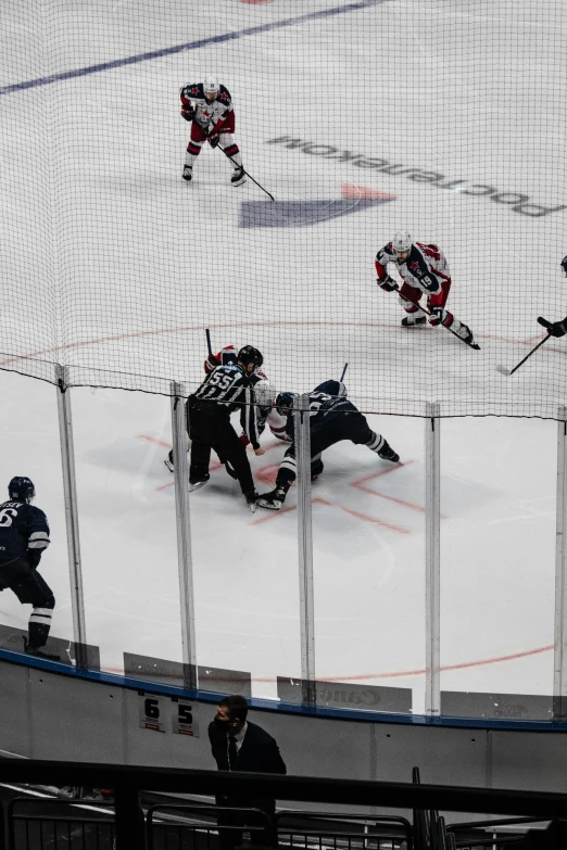 players at the ice hockey rink playing a game