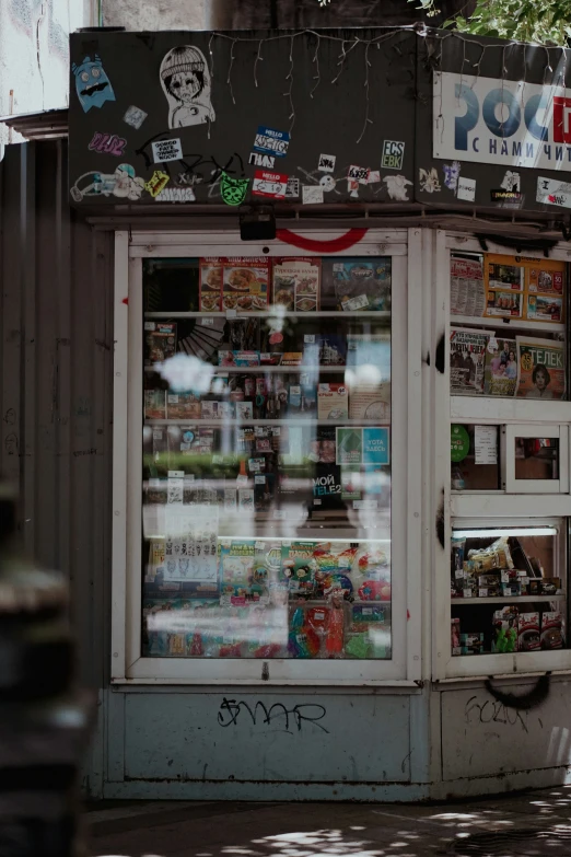 an old storefront covered in many different items