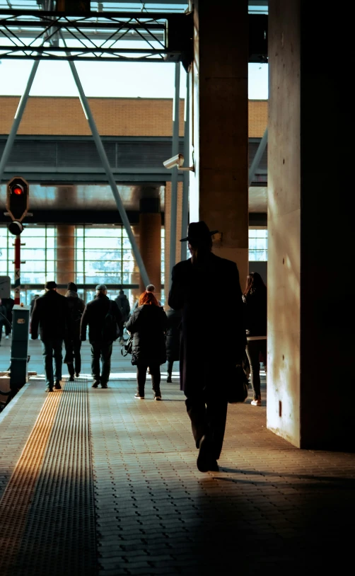 there are many people walking inside this station