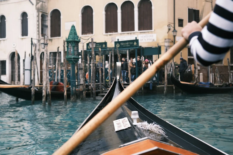 a gondola in front of buildings near water
