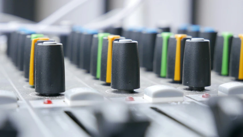 a row of batteries sitting on top of a mixing board