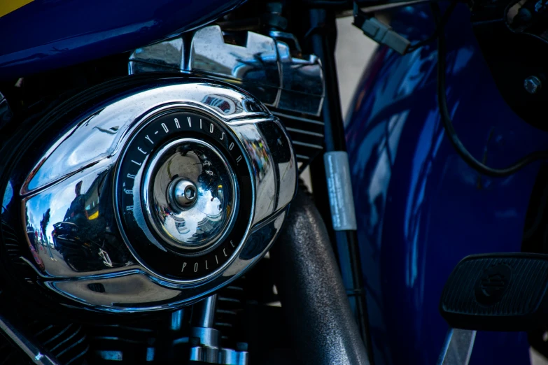 the front part of a motorcycle with a shiny headlight