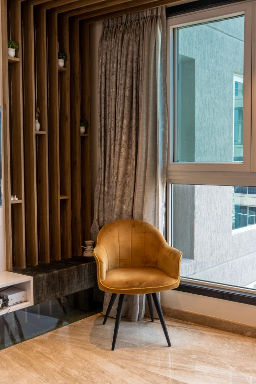 a chair sitting next to a window and a wooden wall