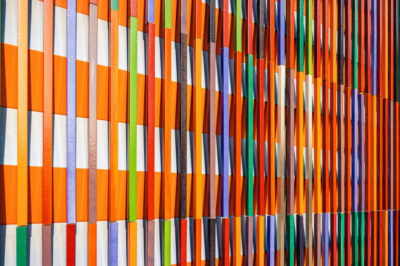 an orange building with lots of different colored strips on the side