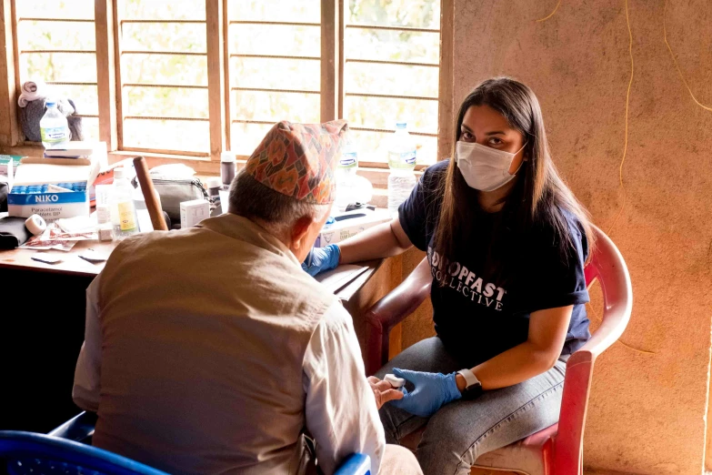 a woman receiving her hands and face mask