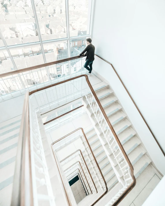 a man walks down a spiral stair case