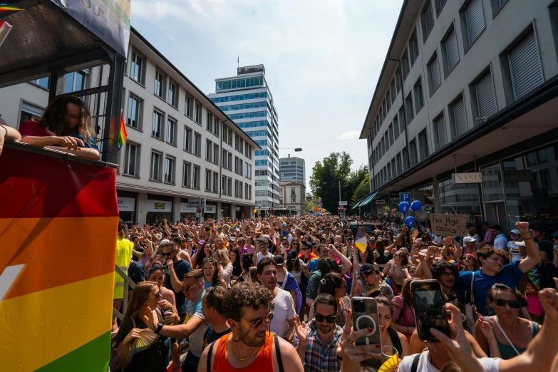 people at a gay pride parade and one person is holding a microphone