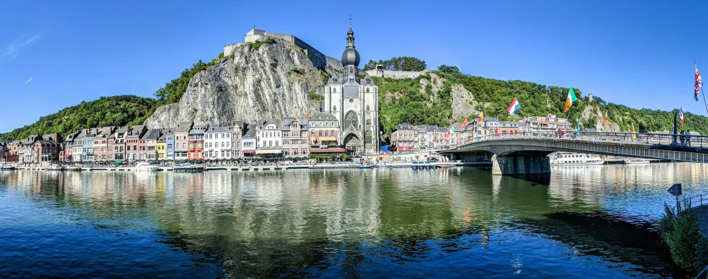 a bridge across the water leads to a town with tall buildings