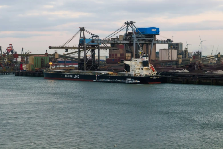 a boat docked next to a pier in the middle of water