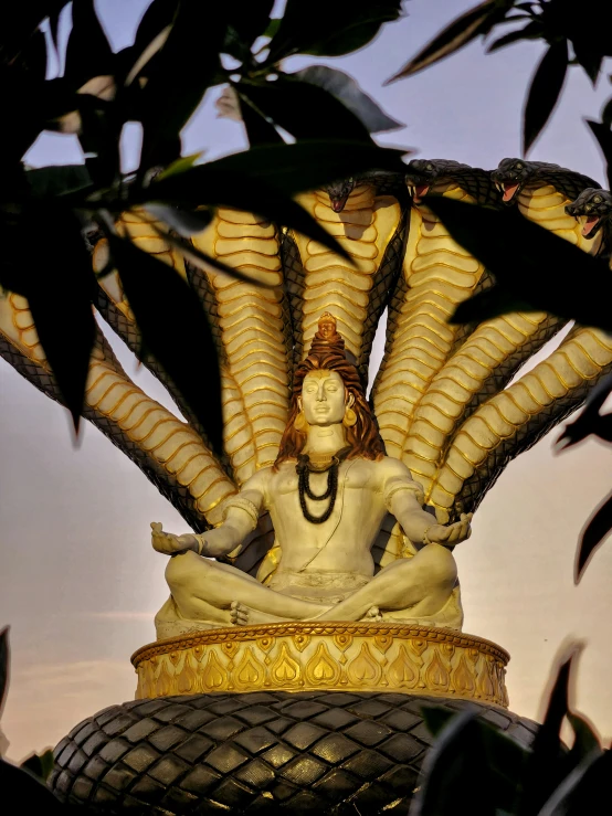 a statue of a woman sitting on a pile of bananas