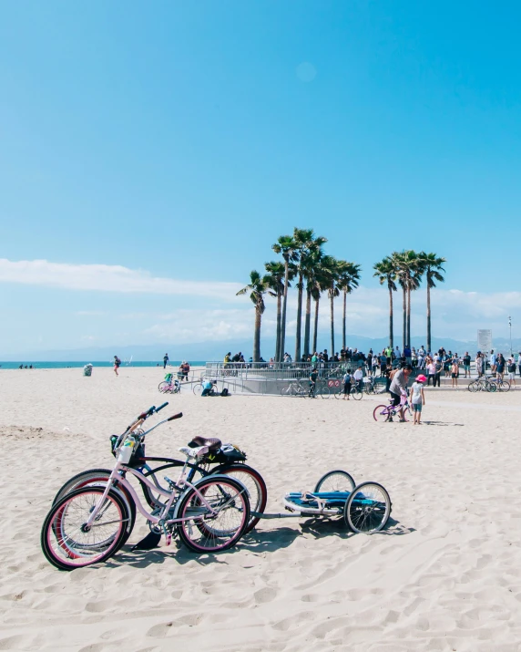 bicycles parked in the sand on the beach