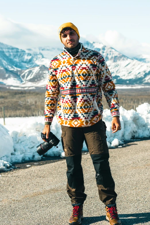 a man in snow gear poses for a pograph