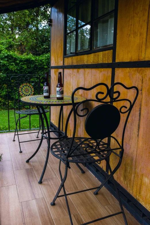 a wooden patio with iron garden furniture