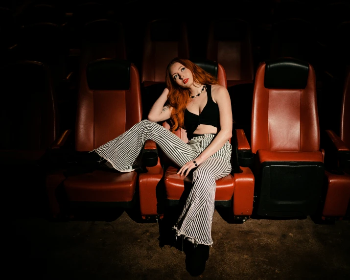 a woman sitting in a chair and looking back at her