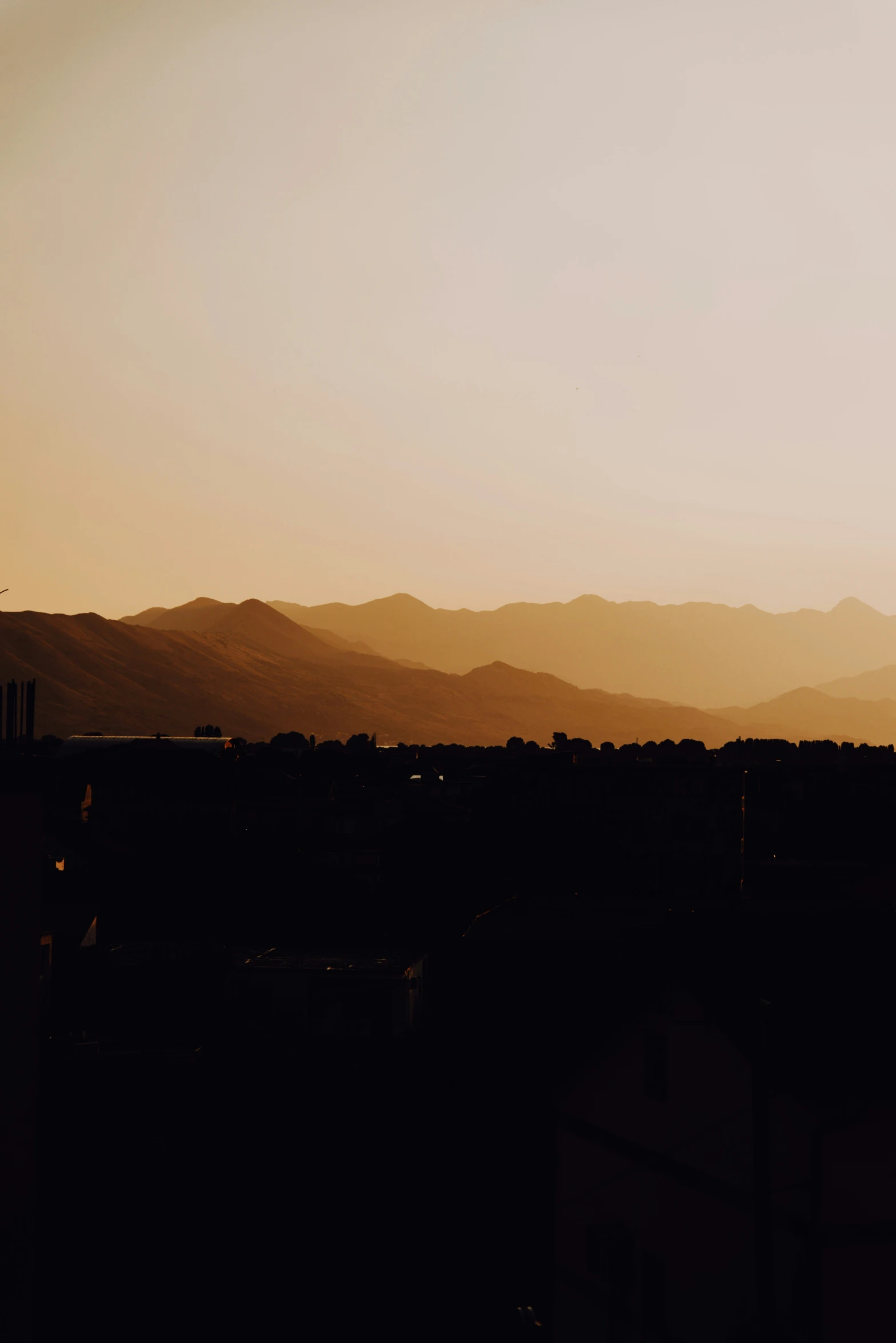 silhouette of building with mountains in the background