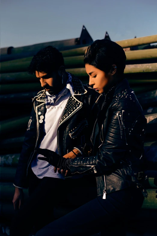 two people sit together in the sun