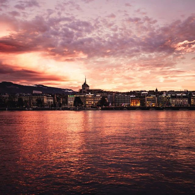 view of the water and a large city during sunset