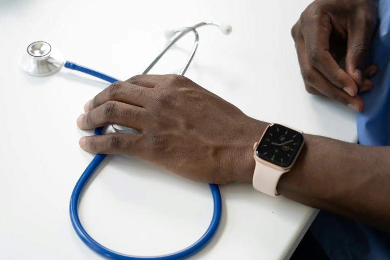 a person wearing a blue medical watch and a blue celet