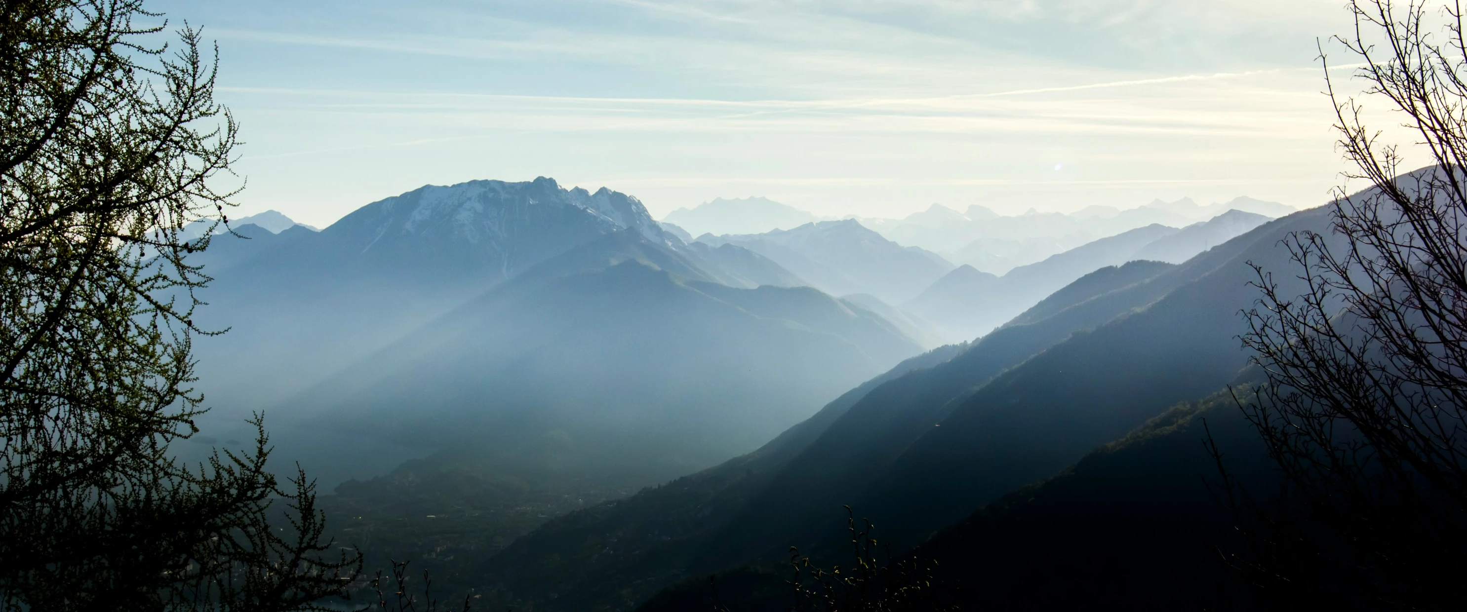 some mountains are shown in the background with sunlight coming through them