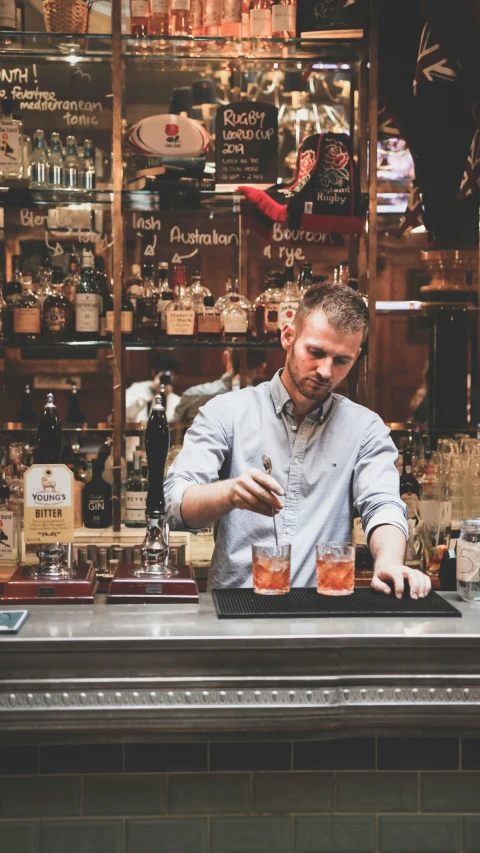 a bar that has people in it, and shelves of liquor