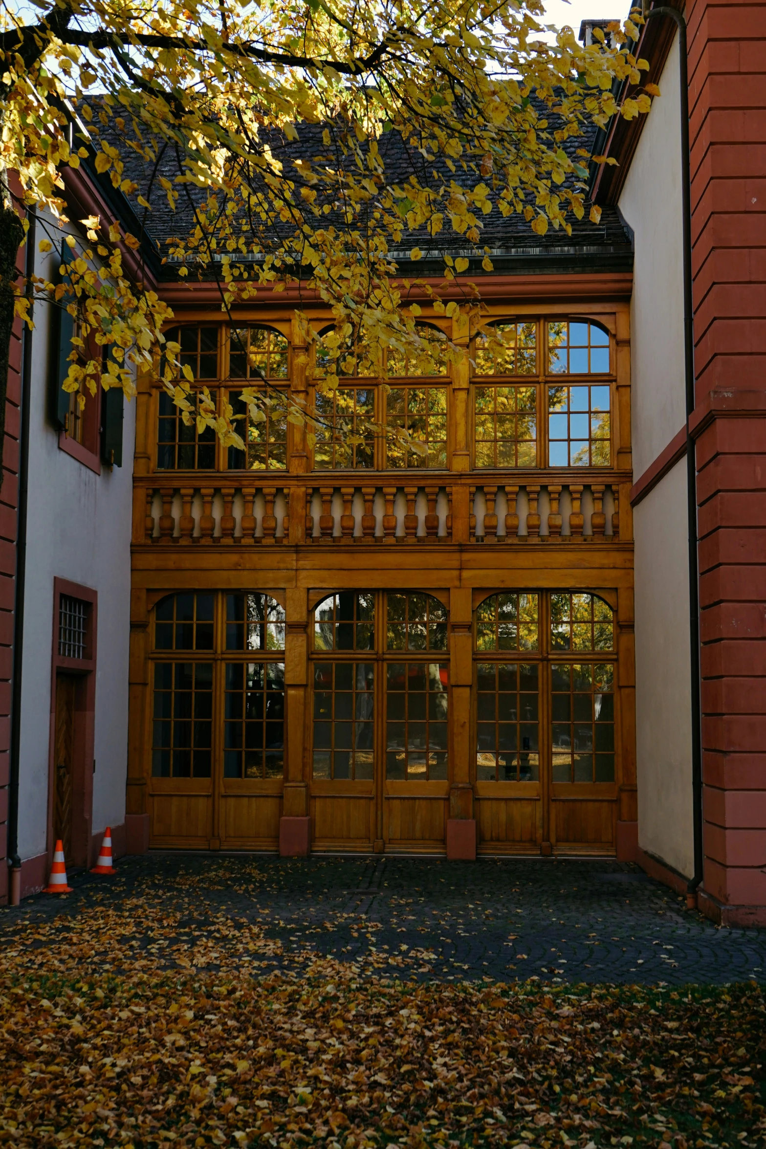 leaves cover the ground near the entrance to a building